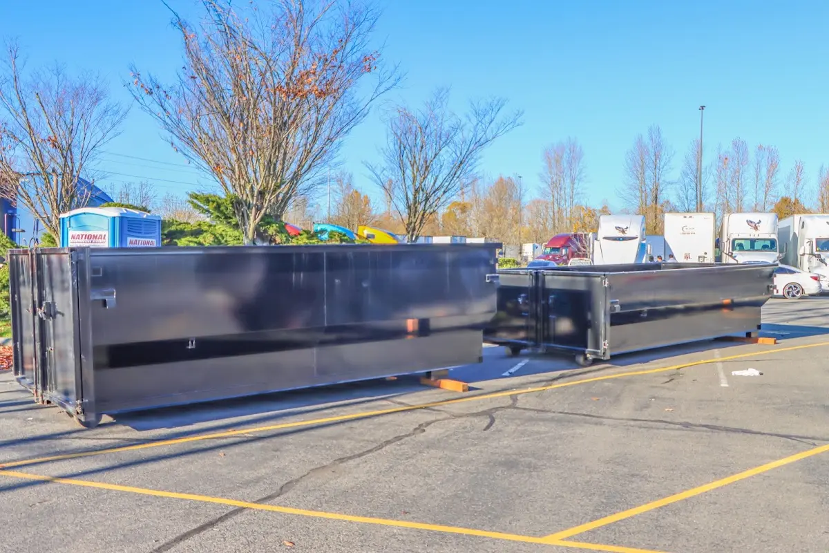 Professional dumpster rental service with roll-off container on residential driveway in Lamar